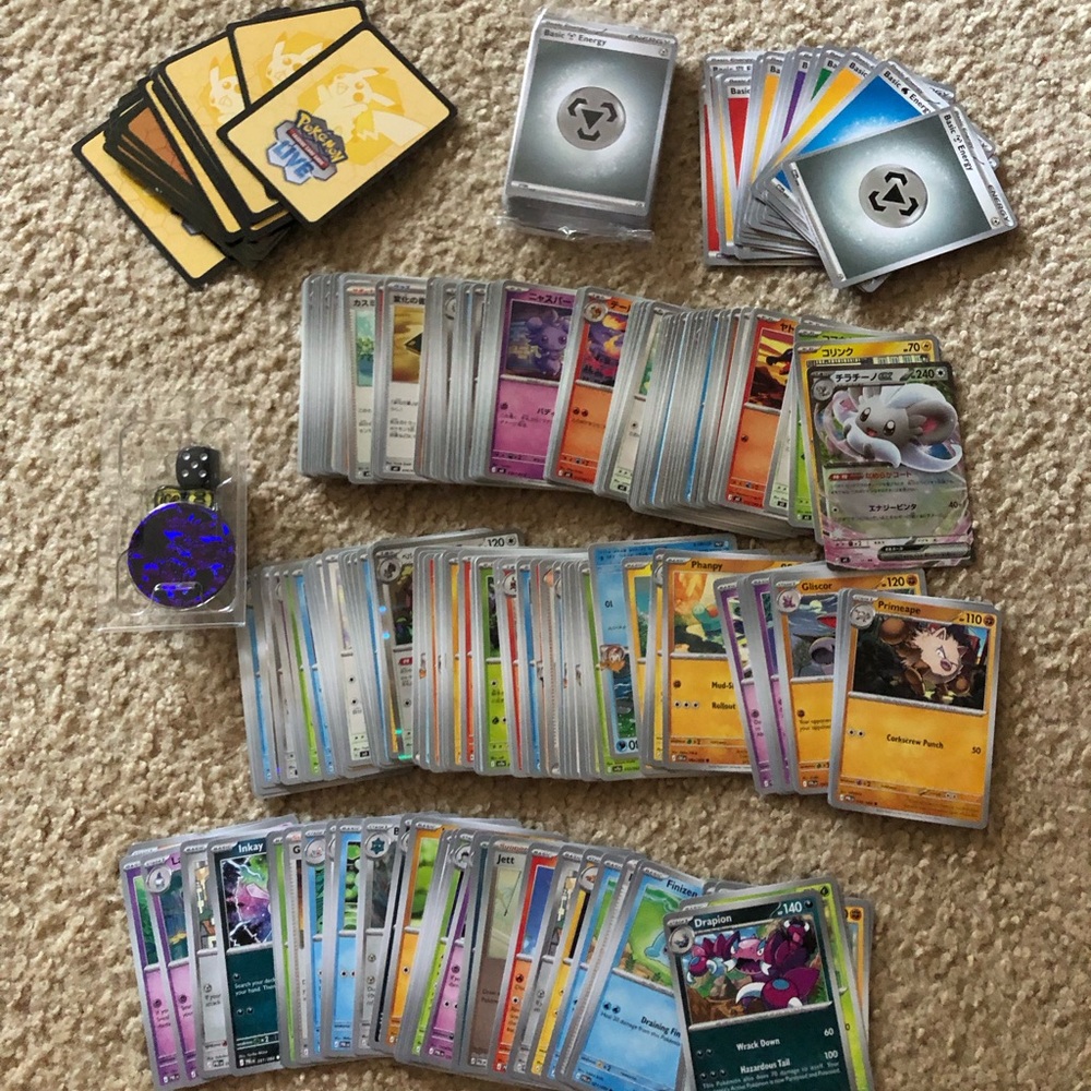 Pokemon card bulk cards, coin and dice, energy cards, and unused digital codes
